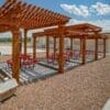 Pergolas in CHH Jal lodge with sitting areas arranged on round tables by the basketball courtyard