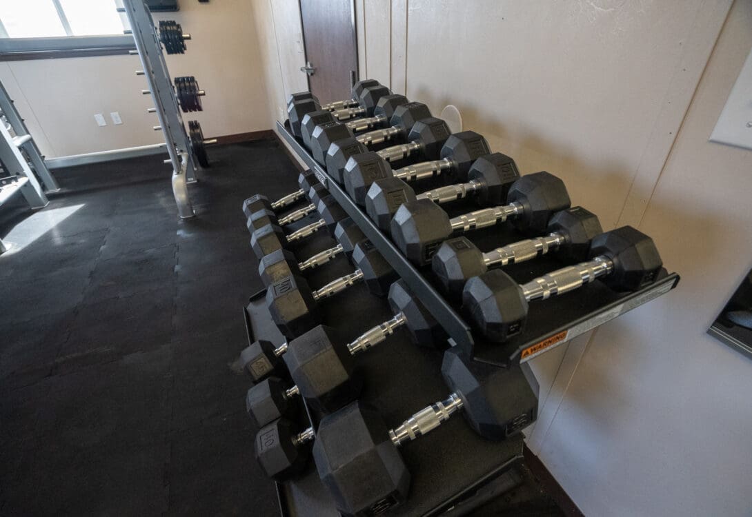 A close up of the dumbbell weight set in the work out room in CHH Pecos