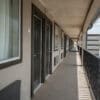 A long shot of the hallway in front of the room units in CHH Big Spring location facing outside the parking lot