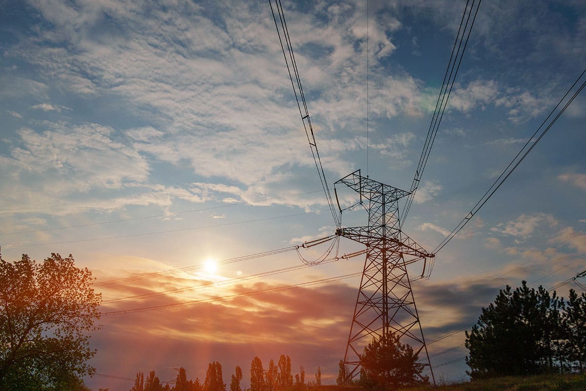 An upward shot outside one of the CHH properties that shows utility infrastructures and captures the sky on a setting sun for background