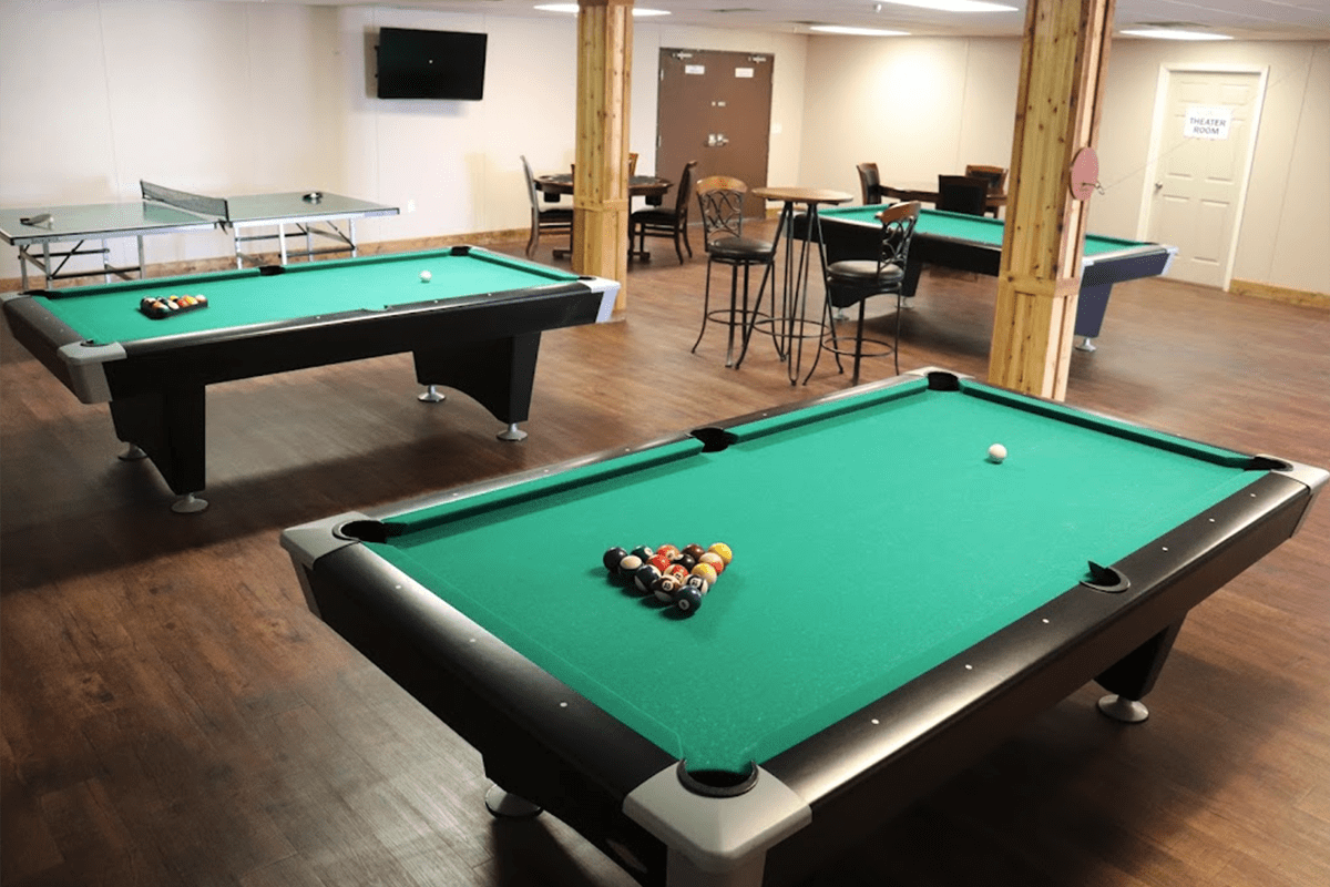 A view in CHH Orla Lodge rec room with pool tables and a pingpong table