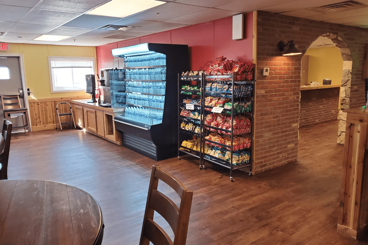 Snack bar in CHH Orla with choices of chips and other wrapped baked goods, a coffee and bottled water station.