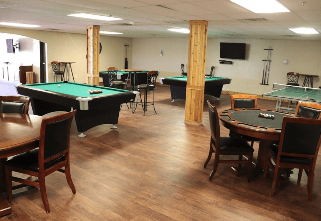 The rec/game room in CHH Orla Lodge with pool, pingpong and card tables